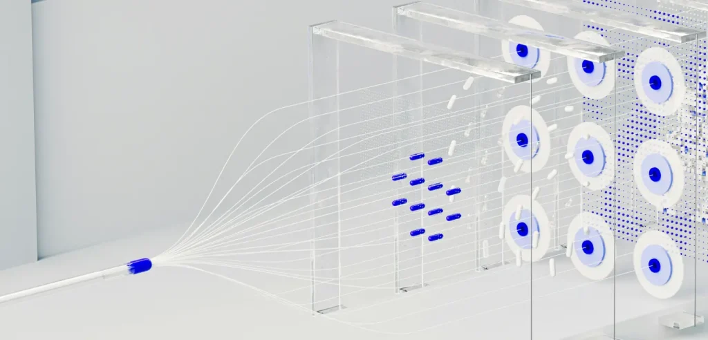Fiber optic test bench with transparent panels, white cables fanning out from a connector toward blue-centered reels on a rack.